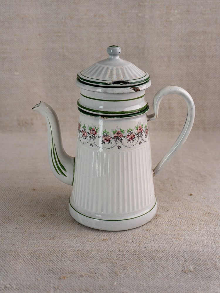 Antique French enamel coffee pot by B.B. Frères, 1910-20s, with lid, green trim, pink-green floral accents on neutral surface.