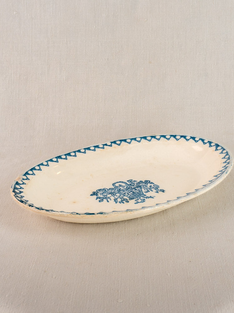 Antique French faience oval plate by Bertrand Opaque Surfine with blue flower basket and zigzag rim on light beige earthenware.