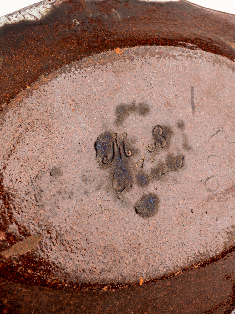 Base of 18th-century French Orléans faience platter with textured rusty brown glaze, stamped "M.B" and faint marks.