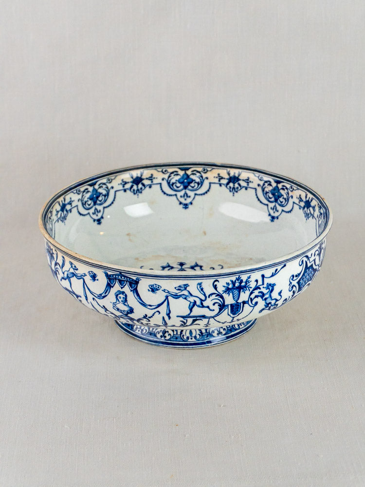 Antique French blue faience ceramic bowl with Moustiers-style floral and scroll motifs on white.