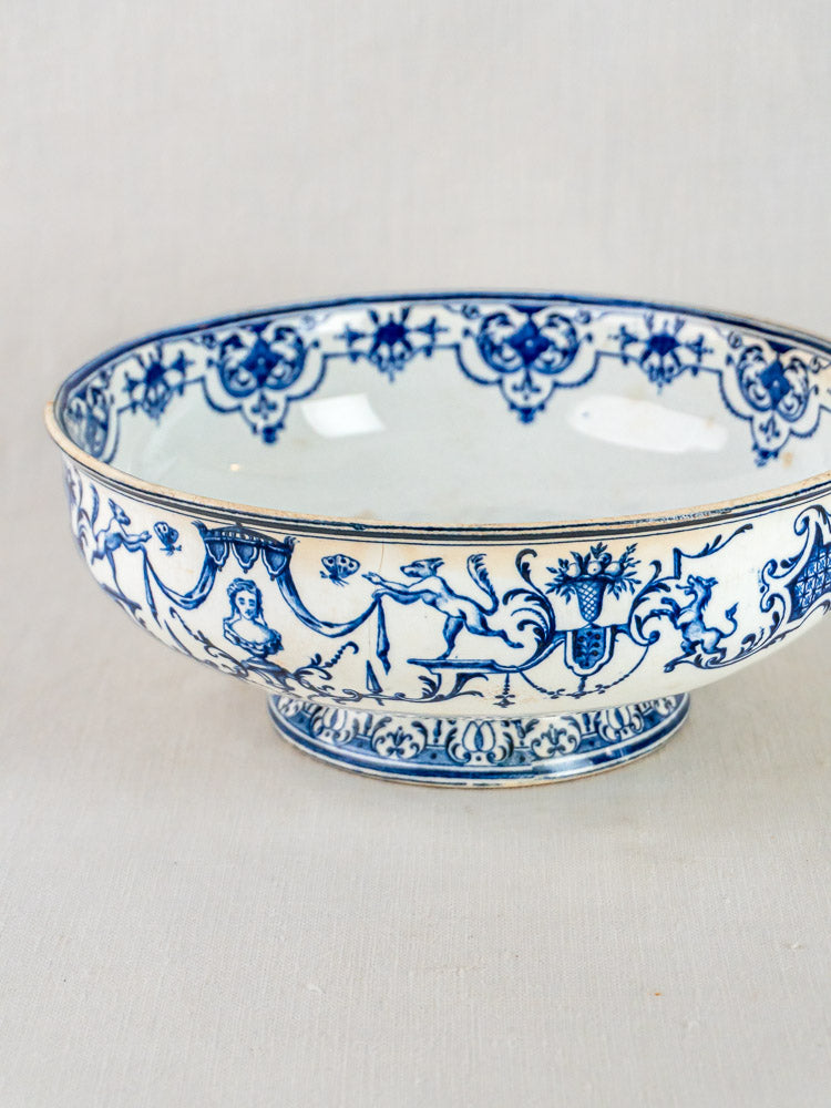 Antique Jules Vieillard Bordeaux faience bowl with blue animals, people, and floral motifs on white.