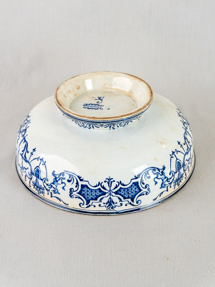 Upside-down Jules Vieillard Bordeaux Moustiers bowl with antique French blue faience floral patterns on white.