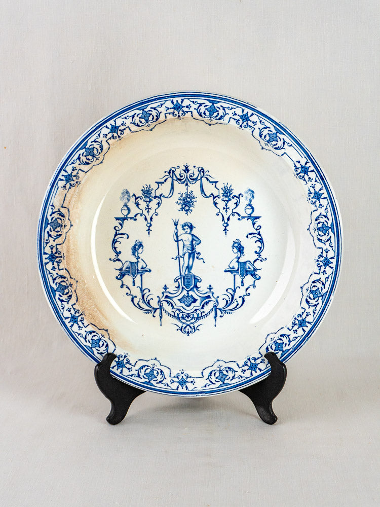 Jules Vieillard Bordeaux Moustiers Service blue faience plate with floral motifs, upright on black stand.