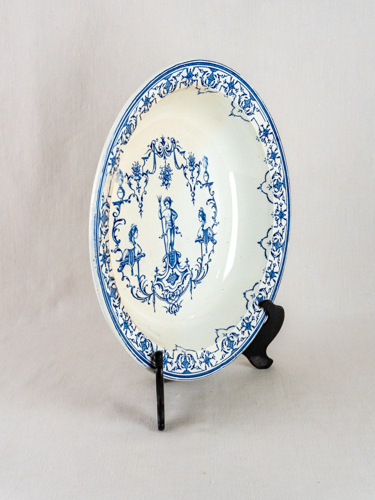 Antique French blue faience plate, Jules Vieillard Bordeaux Moustiers, with ornate patterns and central figure on black stand.
