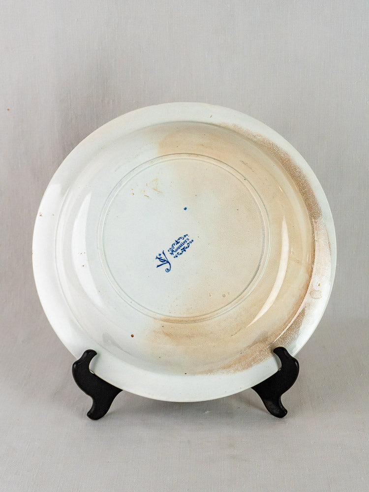 Back of a white ceramic plate with brown stains, featuring blue Jules Vieillard Bordeaux mark.