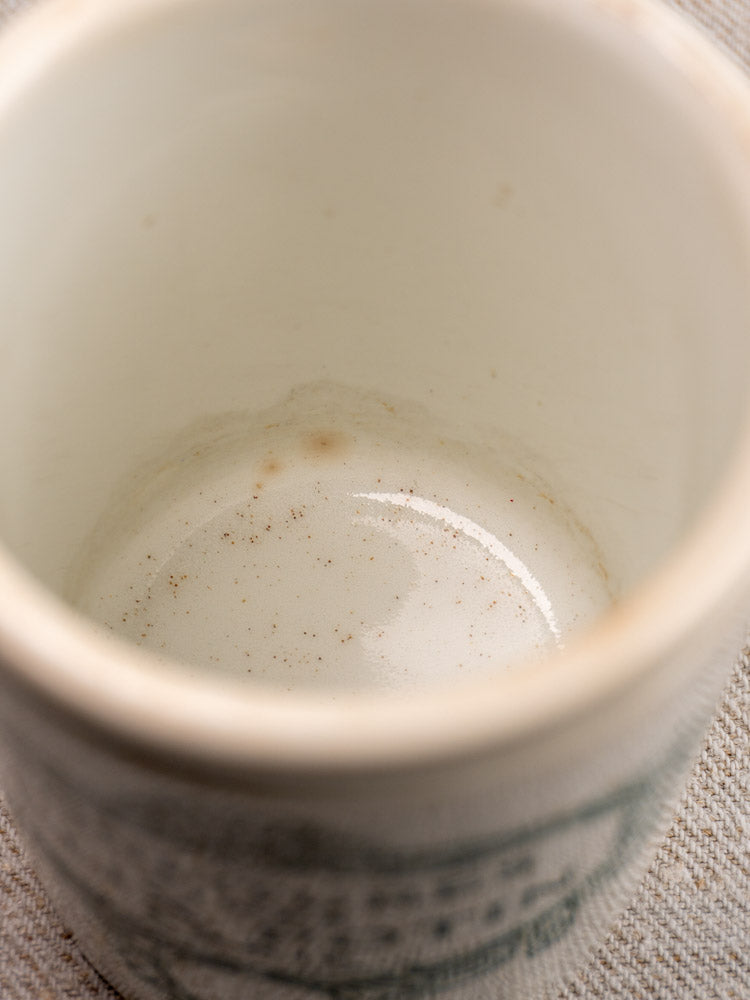 Interior close-up of antique French Felix Potin jam pot showing brown stains and residue at the bottom.
