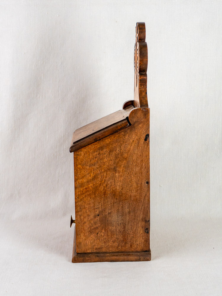 Carved walnut French antique wall-mounted flour and salt box with hinged lid, folk art design, on white background.