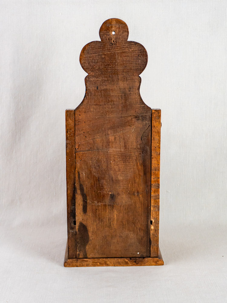 Antique French carved walnut flour and salt box with rounded back, displayed on a plain background.