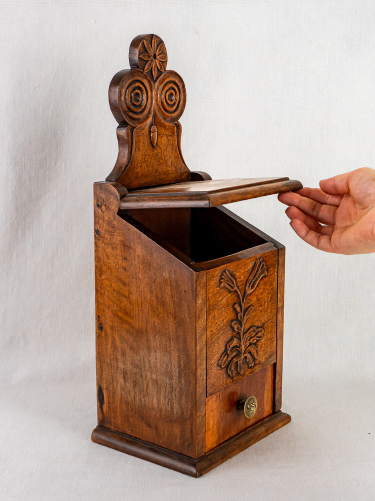 Hand opens carved walnut French flour and salt box with floral motifs and small bottom drawer.