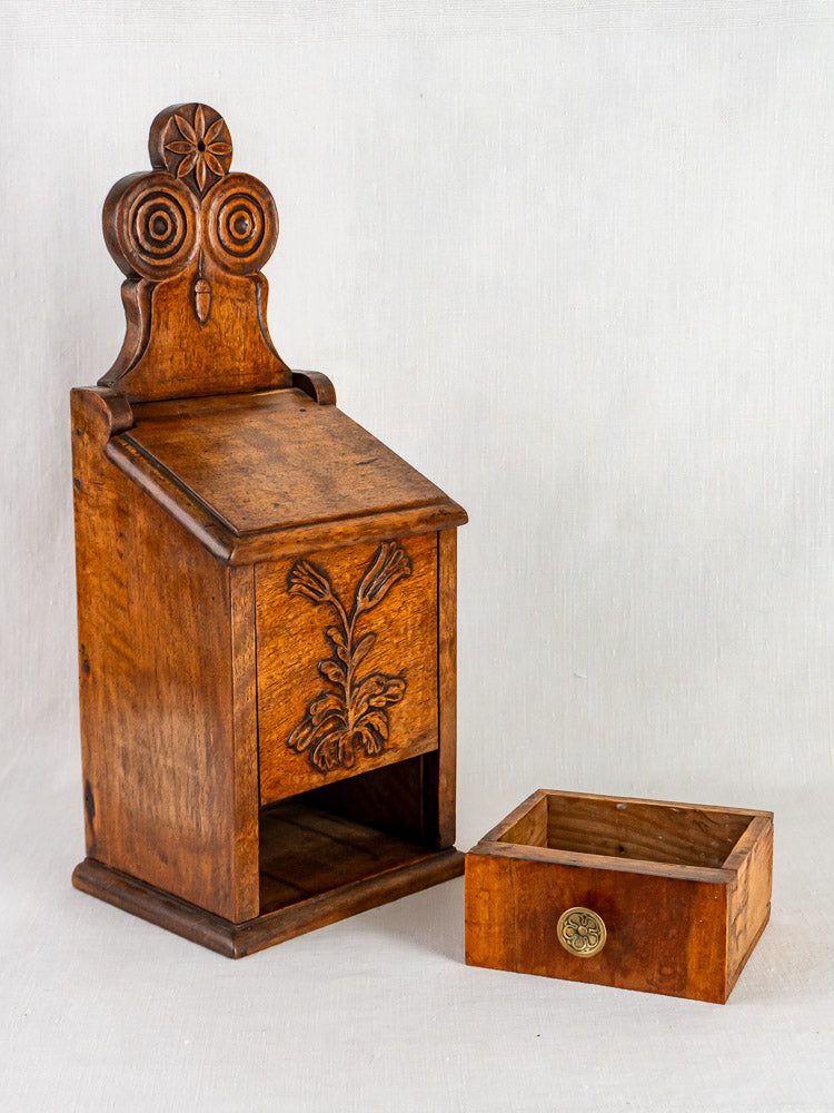 Antique French carved walnut wall-mounted flour and salt box with ornate floral design and open compartment.