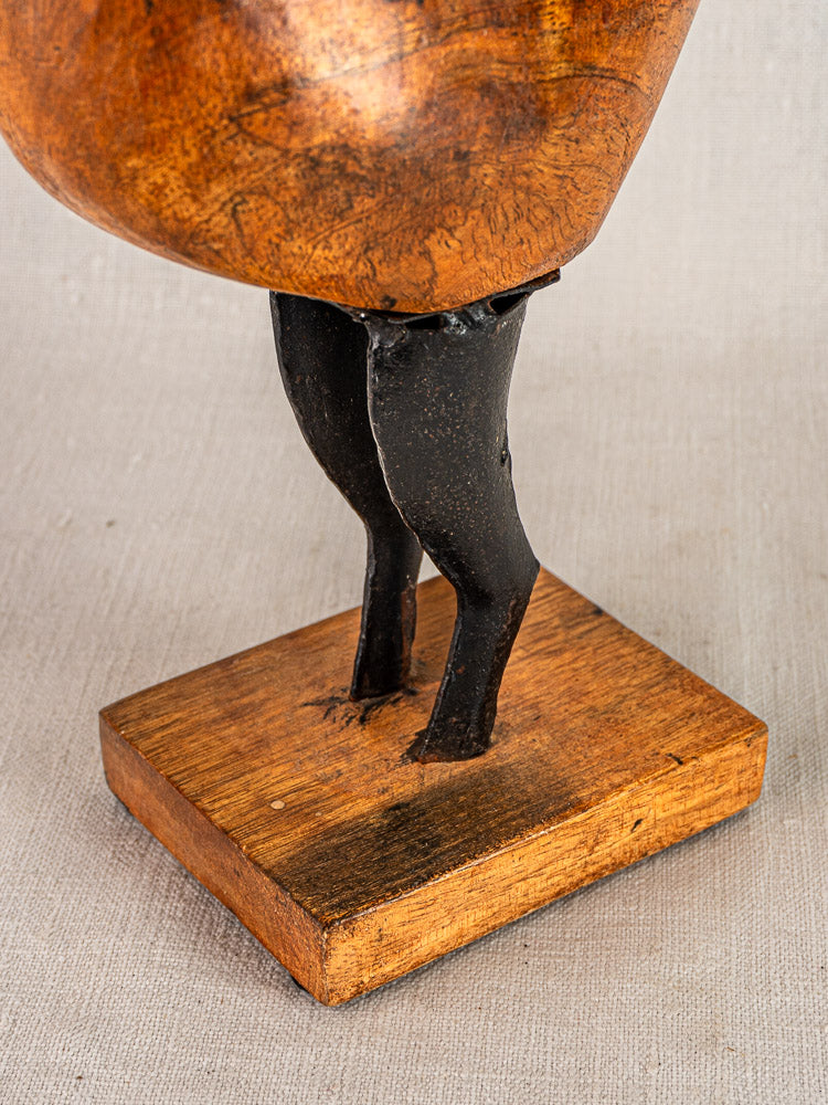 Antique French carved wood and metal folk art rooster on base, shown on light textured surface.