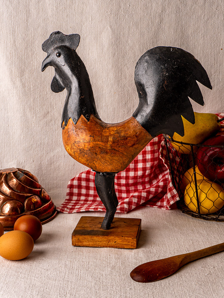 Antique French carved wood and metal rooster sculpture, black and brown, on wooden base.