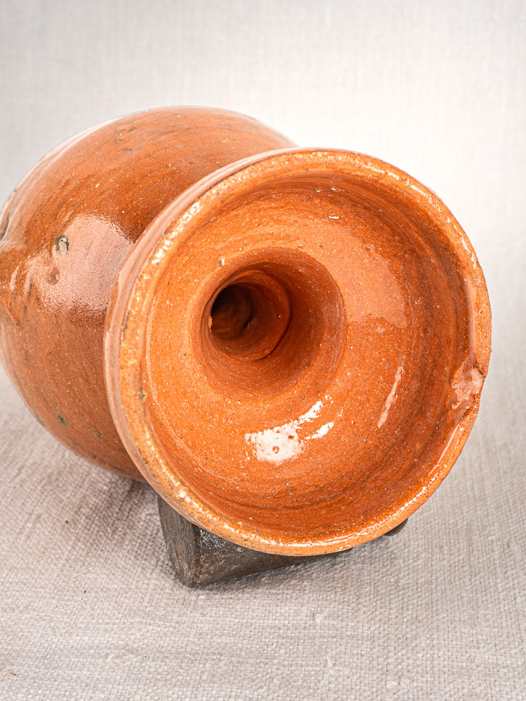 Antique French glazed terracotta mammiforme jug from Provence, round mouth, on textured beige fabric.