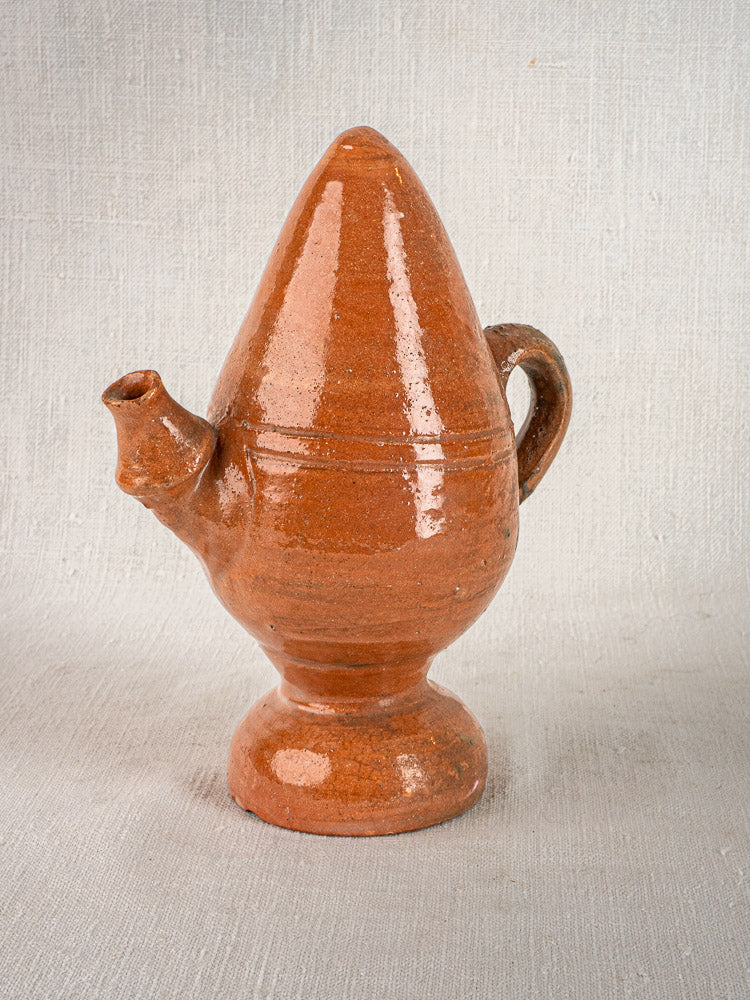 Antique French glazed terracotta jug from Provence with a brown, cone-shaped body and single handle.
