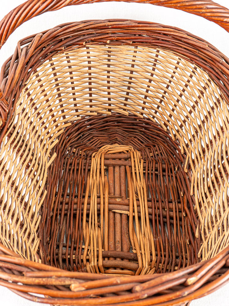 Antique French gathering basket circa 1900 with sturdy handle and two-tone willow weave in light and dark brown.