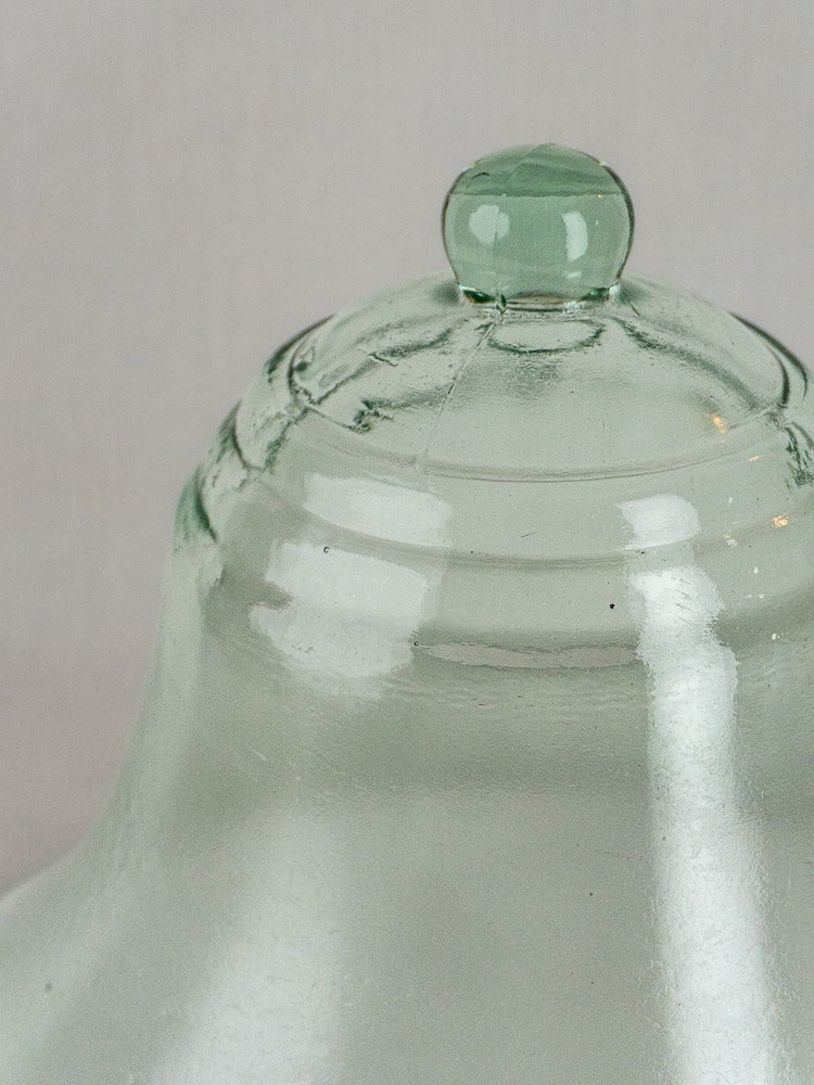 Hand blown 19th-century French glass cloche top with green tint, rounded handle, and ridges.