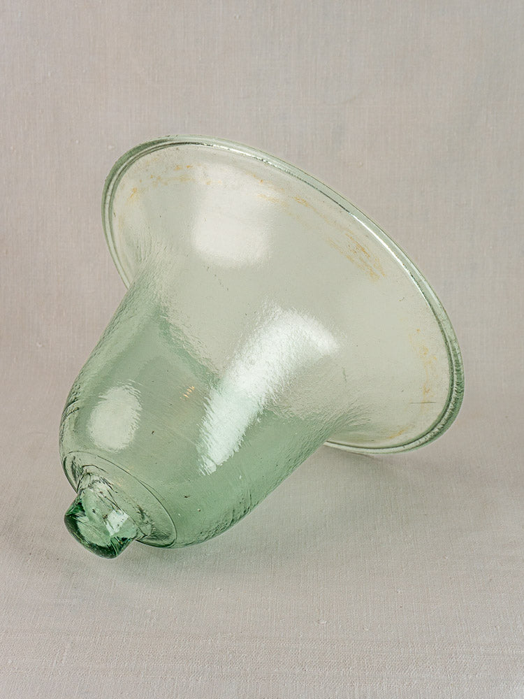 Antique French hand-blown glass garden cloche with greenish hue, wide flared rim, and subtly textured surface.