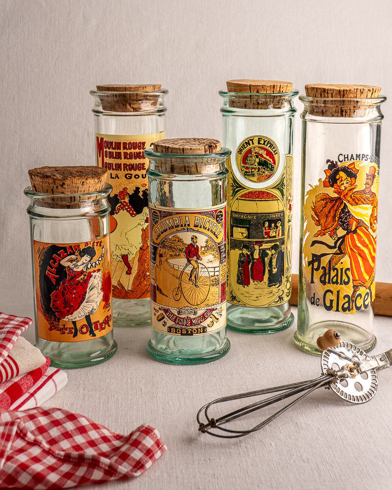 Set of five vintage French glass jars with cork stoppers, Belle Époque poster labels, c. 1970s.