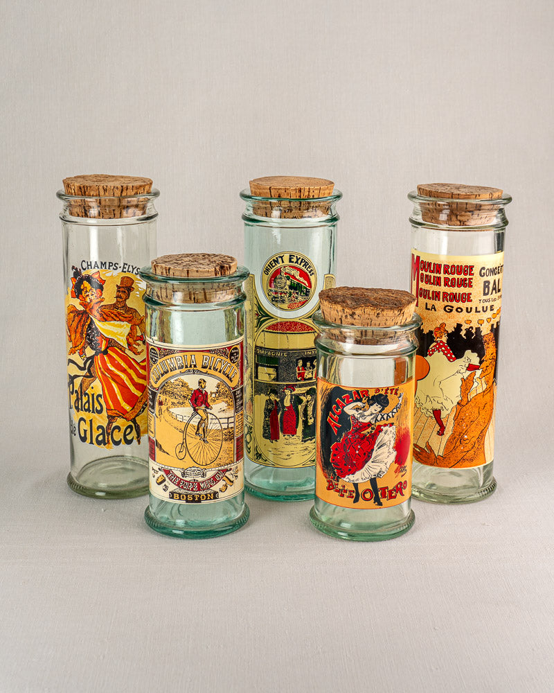Set of five vintage French glass jars with cork stoppers, Belle Époque poster labels, c. 1970s.