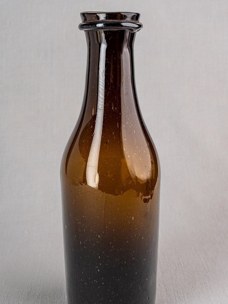 Antique French hand-blown verre soufflé truffle jar with narrow neck and brown glass.