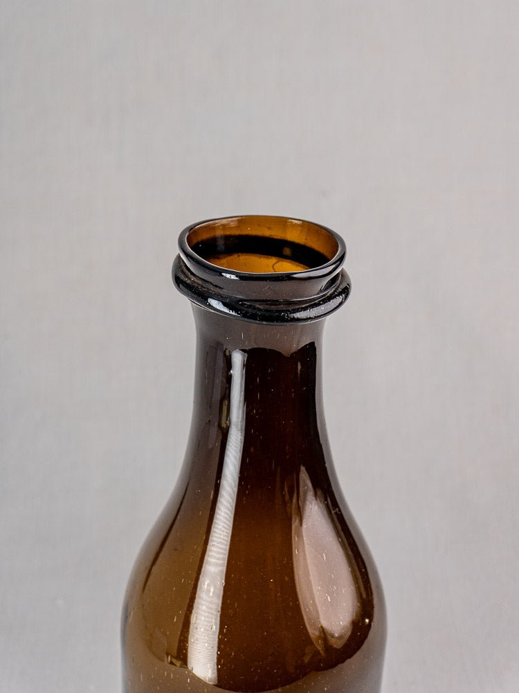 Antique French hand-blown glass truffle jar with distinct glass ring, plain light gray background.