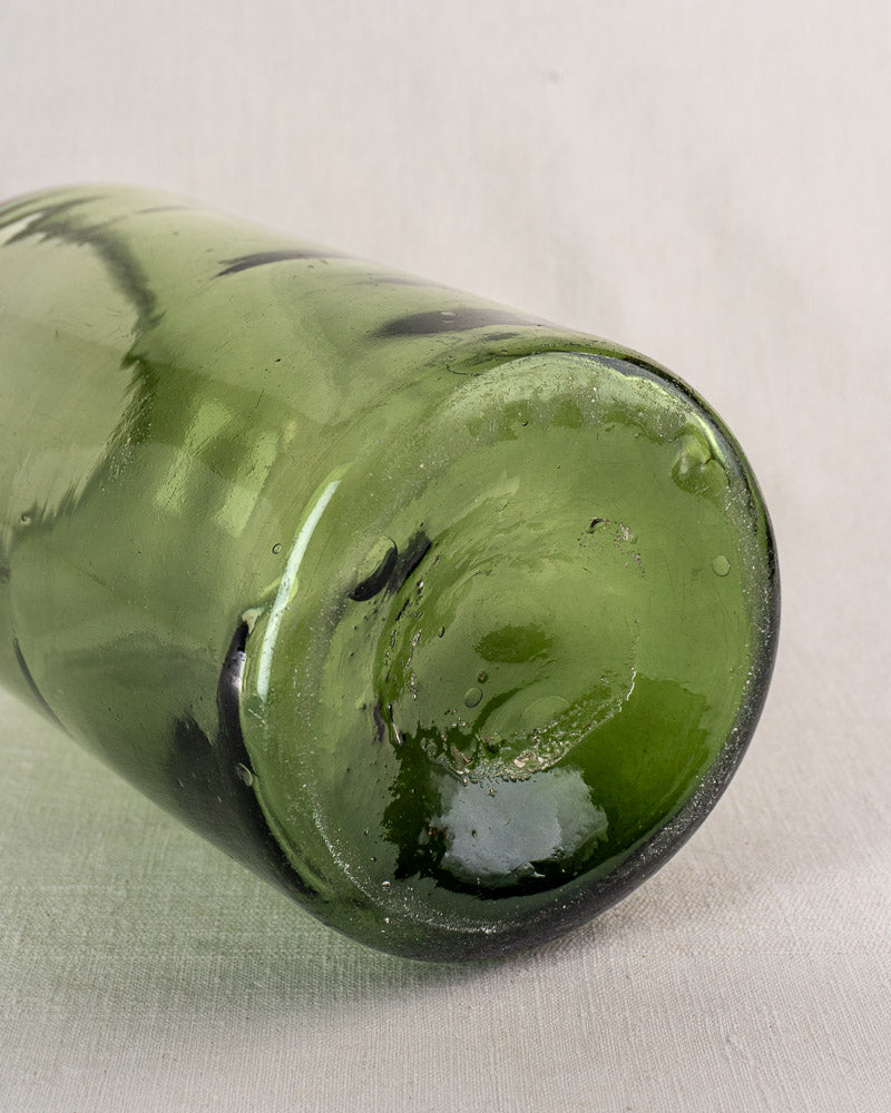 Antique French Cornichon jar base in hand blown green glass with rounded form and distinctive glass imperfections.