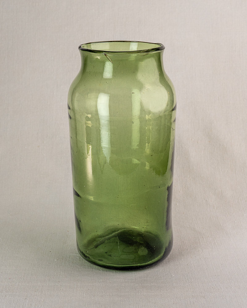 Tall hand-blown green glass French cornichon jar with cylindrical body, flared rim, and 18th-century-style bubbles and imperfections.