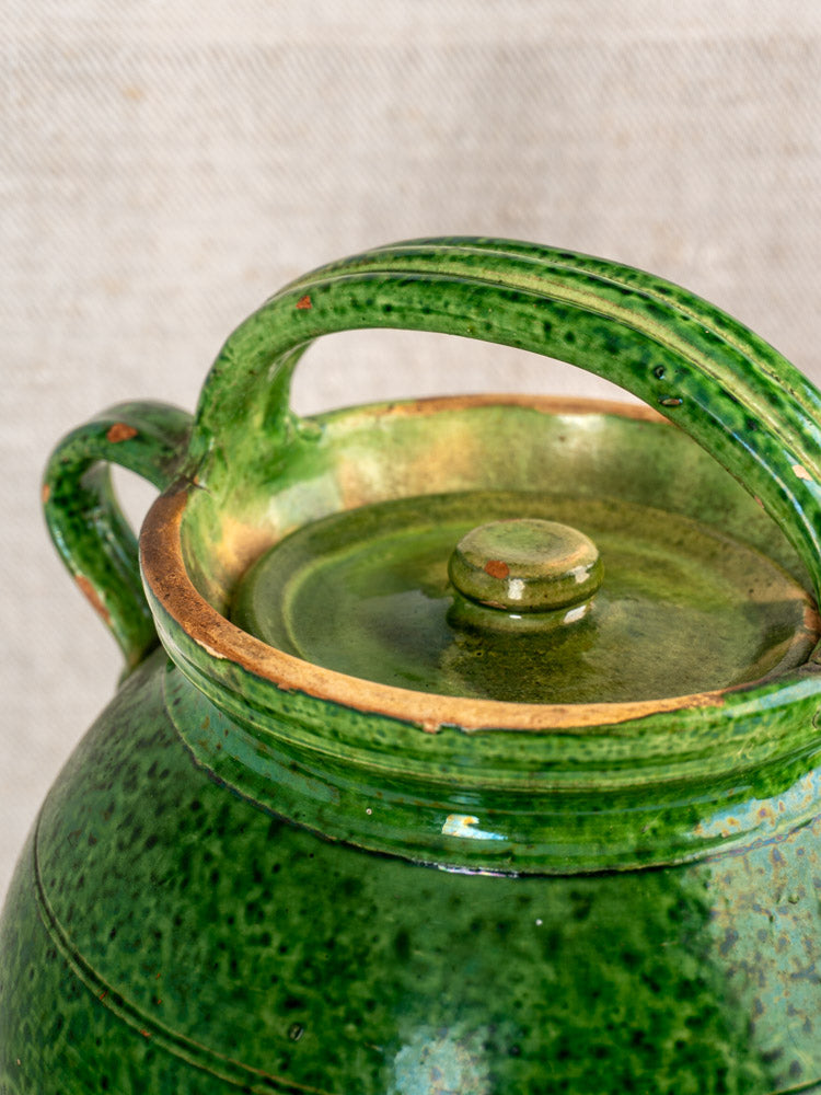 Antique French green glazed cruche Orjol Languedoc water jug with speckled glossy finish, matching lid, large handle.