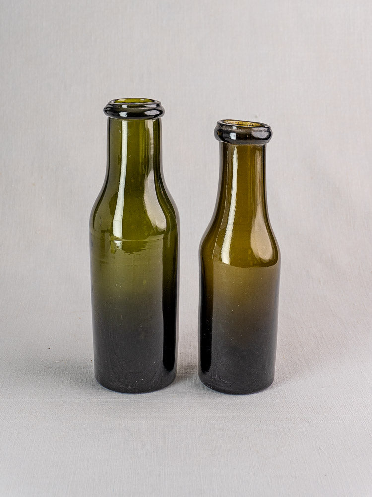 Pair of antique French olive green glass truffle jars with wide rims, 18th–19th century.