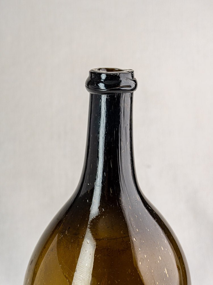 Large antique French hand blown dark olive glass wine bottle with chipped rim, 19th century.