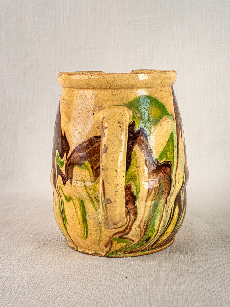 Antique French Savoie Jaspé pitcher with green and brown marbled glaze on tan ceramic.
