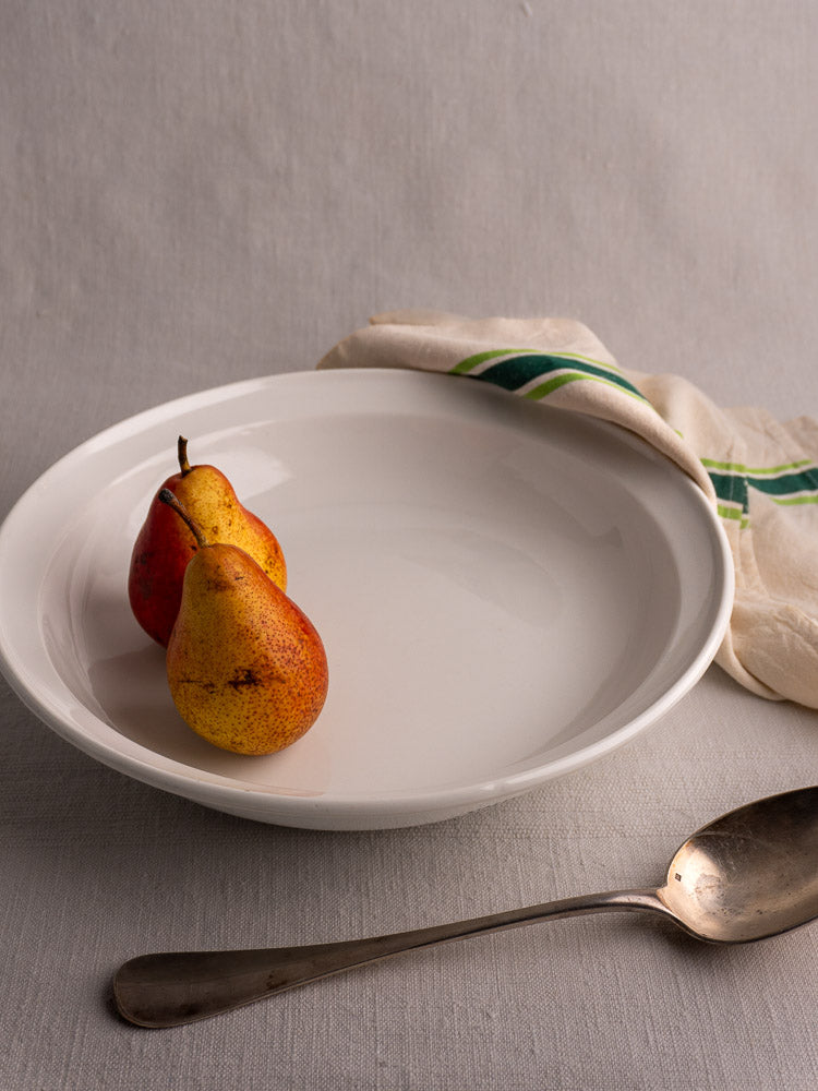 Antique French Aluminite bowl by Frugier Limoges with pears, vintage spoon, and striped cream cloth.