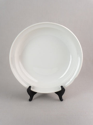 Antique French Frugier Limoges aluminite bowl, early 20th century, upright on black stand, light gray background.