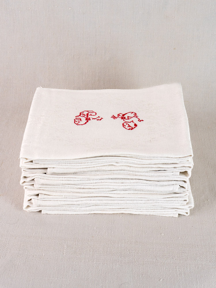 Set of 12 antique French damask linen napkins with red "P.G." embroidered initials.