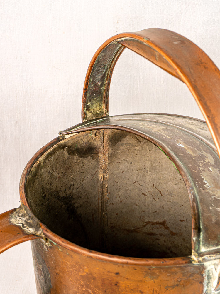 French antique hand-hammered copper watering can with large handle and rich patina throughout.