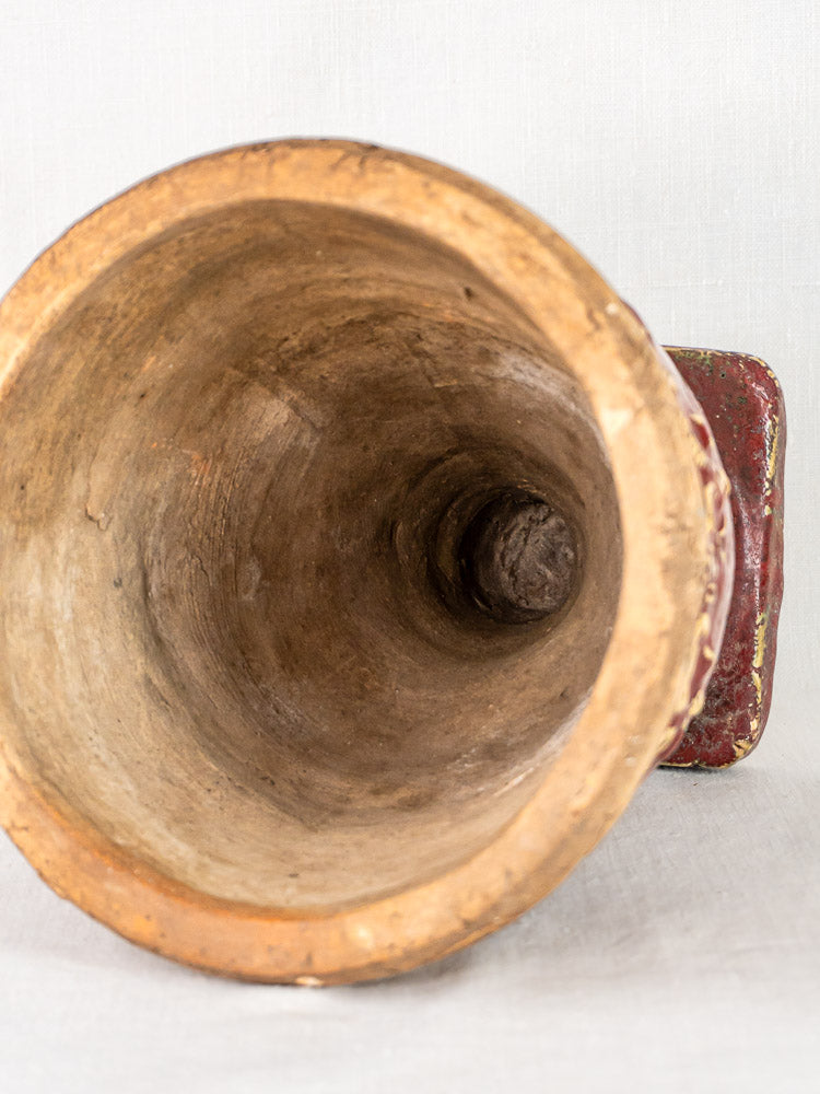 Top view of antique French terracotta urn with oxblood glaze, textured rim and interior, on light background.