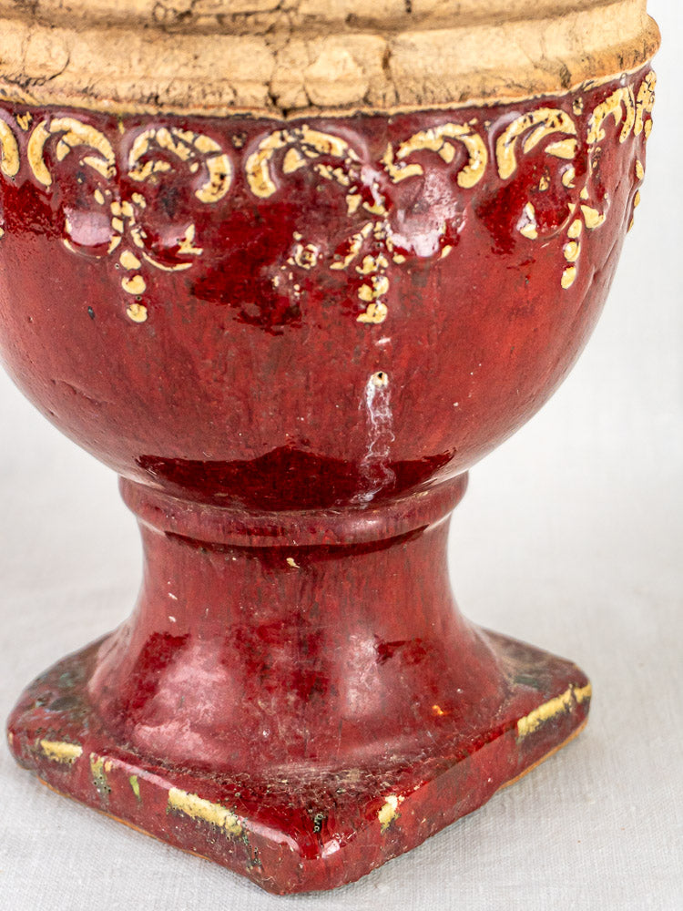 Oxblood French terracotta urn with gold patterns, antique glazed cache-pot, aged finish, chipped paint.