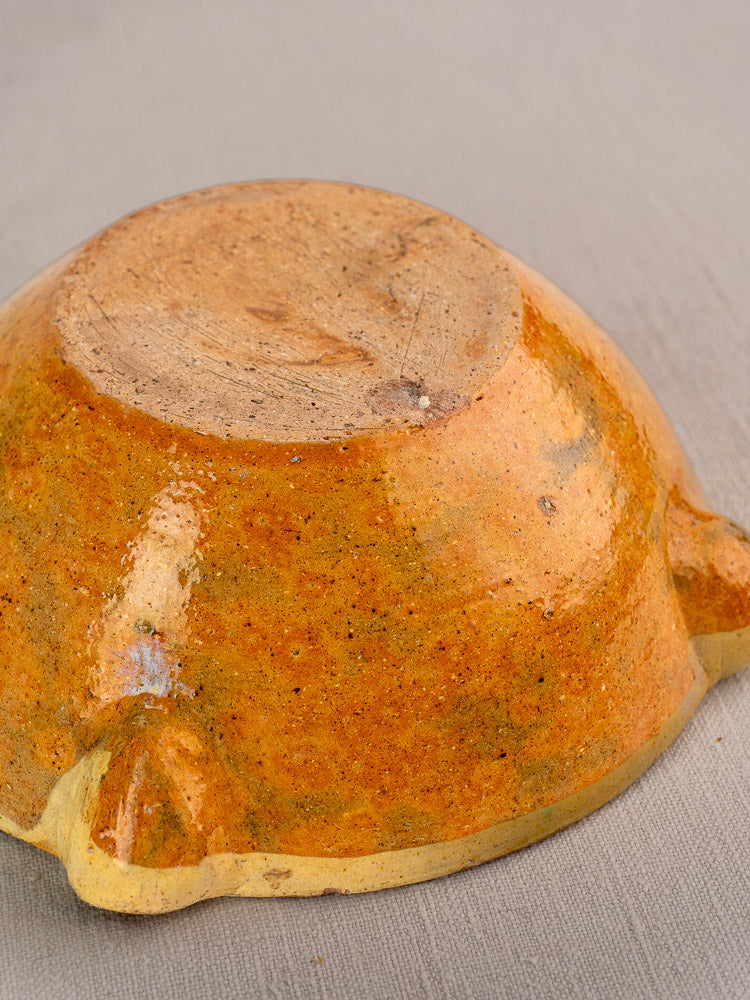 Late 19th-century French yellow glazed mortar with orange ceramic finish and unglazed base on gray surface.