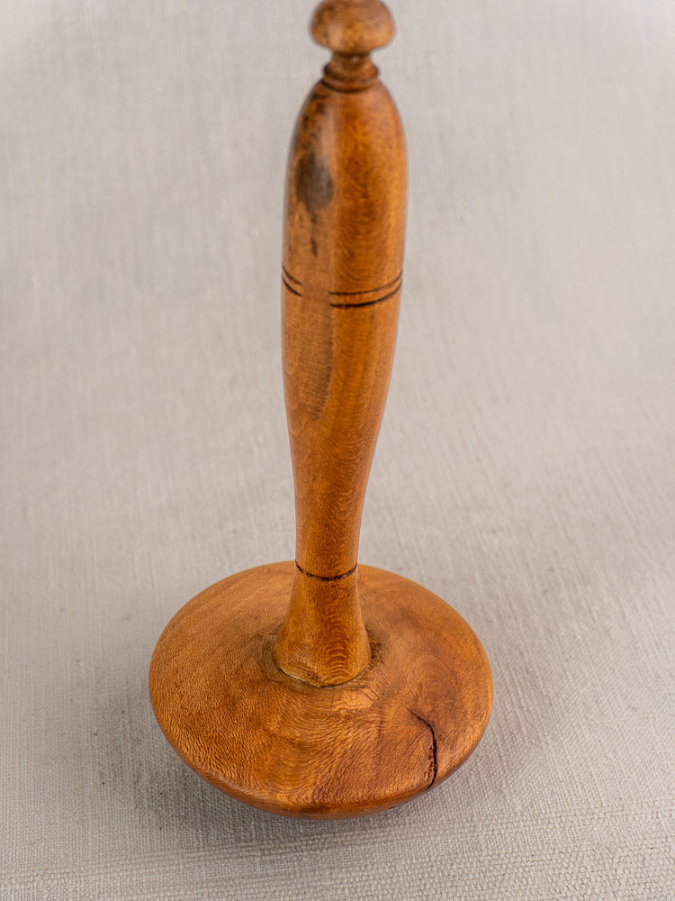 Late 19th-century French Provençal yellow glazed mortar and pestle on a light textured surface.
