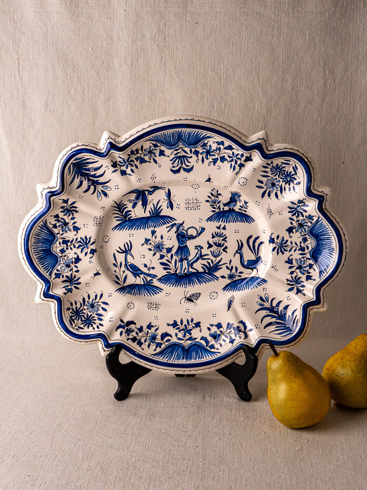 19th century French Moustiers blue and white faience platter on black stand, with two yellow pears.