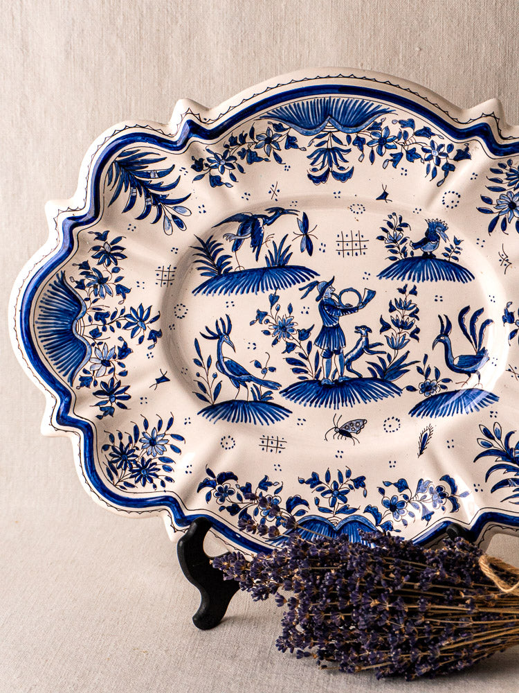 Antique French faience platter in Moustiers blue and white, ornate pastoral motifs, with dried lavender.