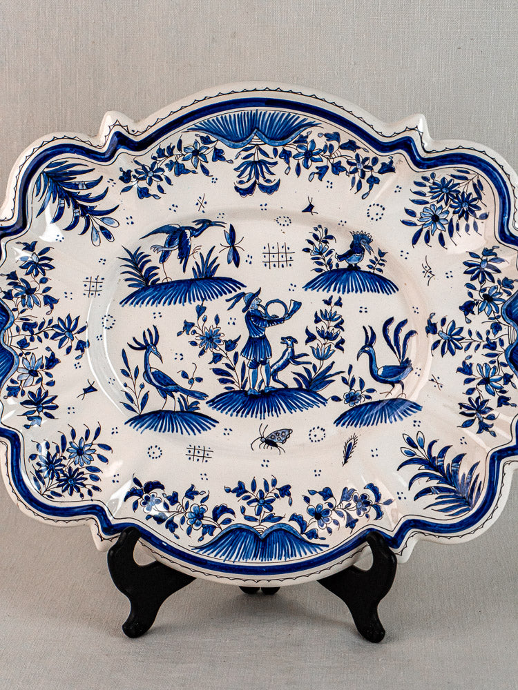 19th century French faience platter with Moustiers blue and white floral and animal motifs on stand.