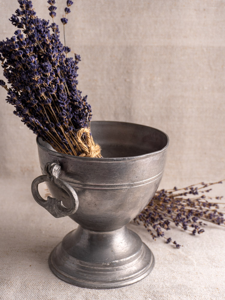 Antique French pewter footed bowl (mid 19th century) with dried lavender, neutral fabric backdrop.