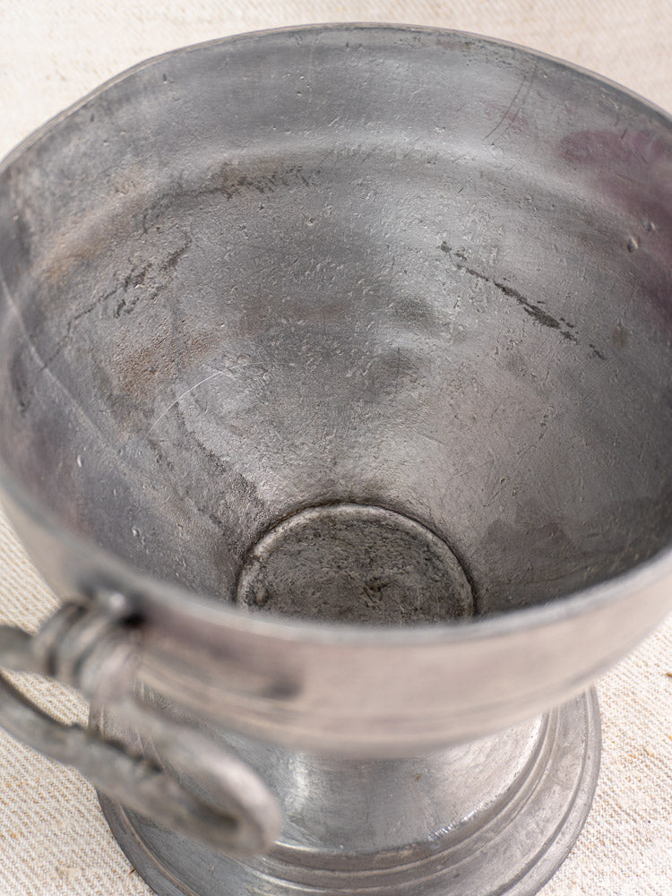 Antique French pewter footed bowl, mid 19th century, with visible scratches and tarnish on textured light surface.