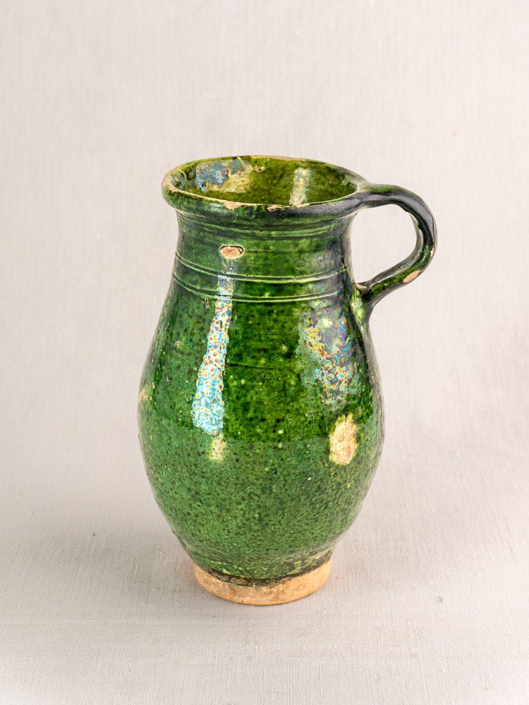Antique French green glazed terracotta pitcher with single handle and narrow neck, Provence pottery style.