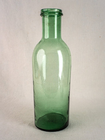 Antique French green bubble glass preserves bottle, hand-blown circa 1900, with narrow neck and unlabeled design.