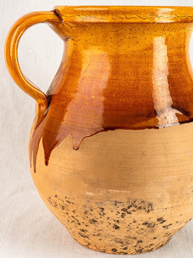Large French Provençal ceramic pitcher with amber glazed top and textured terracotta base.