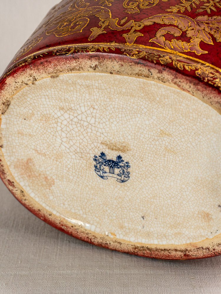 Antique French Terre de Fer wine cooler with gold patterns, maker’s mark, and aged red ceramic finish.