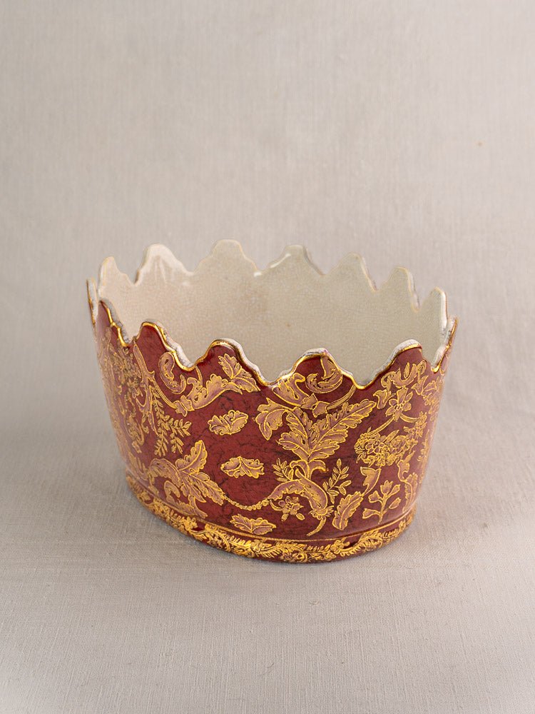 Late 19th-century French Terre de Fer ceramic wine cooler with gold floral motifs on maroon and cream interior.