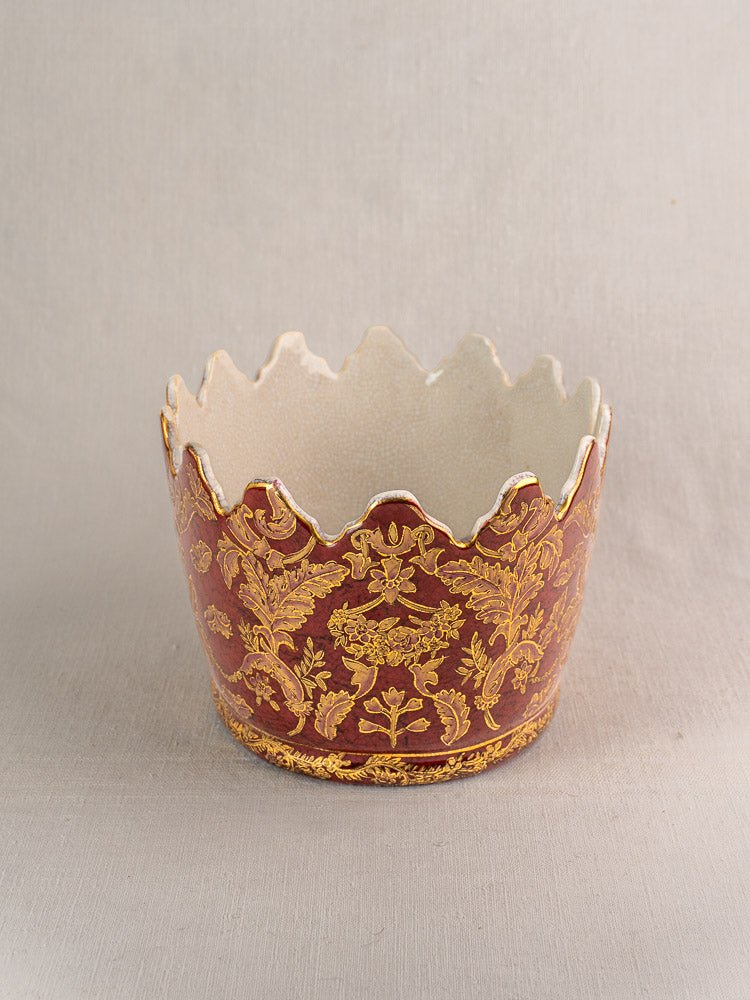 Antique French Terre de Fer wine cooler with scalloped rim, gold floral design, deep red exterior.